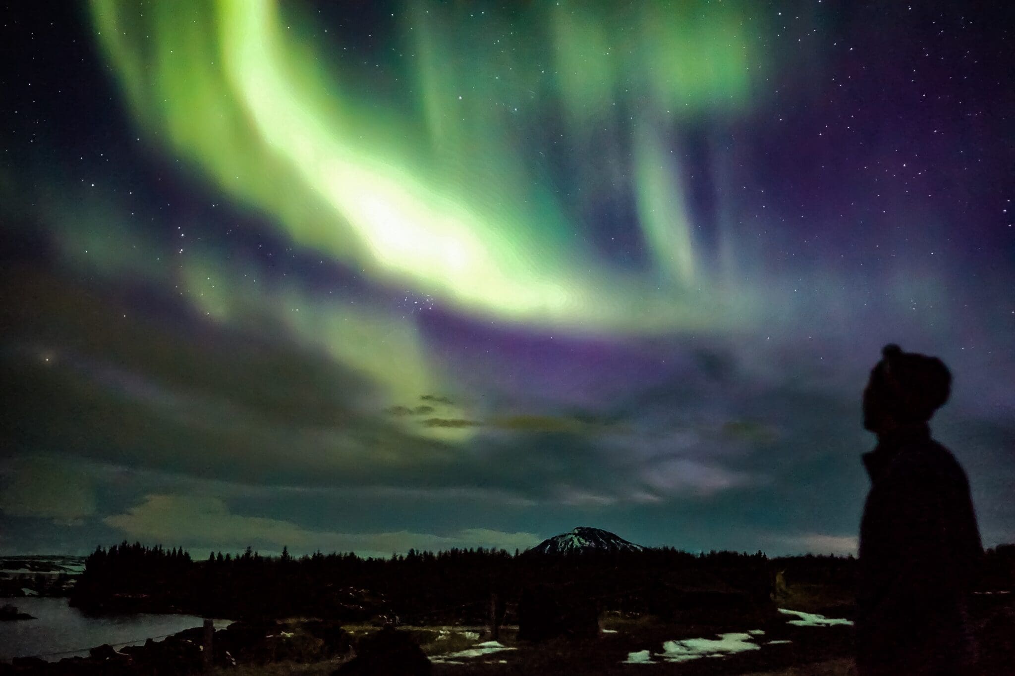 northern lights above mountains